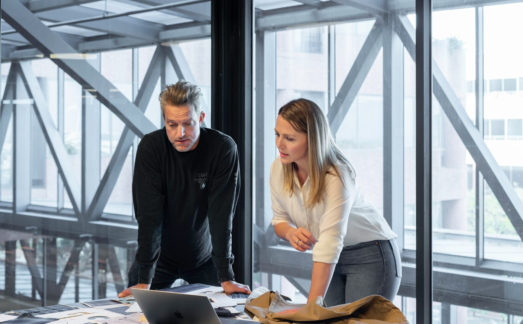 two coworkers at a table in a modern office